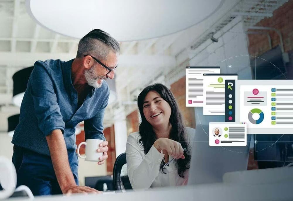 Two people in an office, smiling and interacting, with overlay graphics of documents and charts
