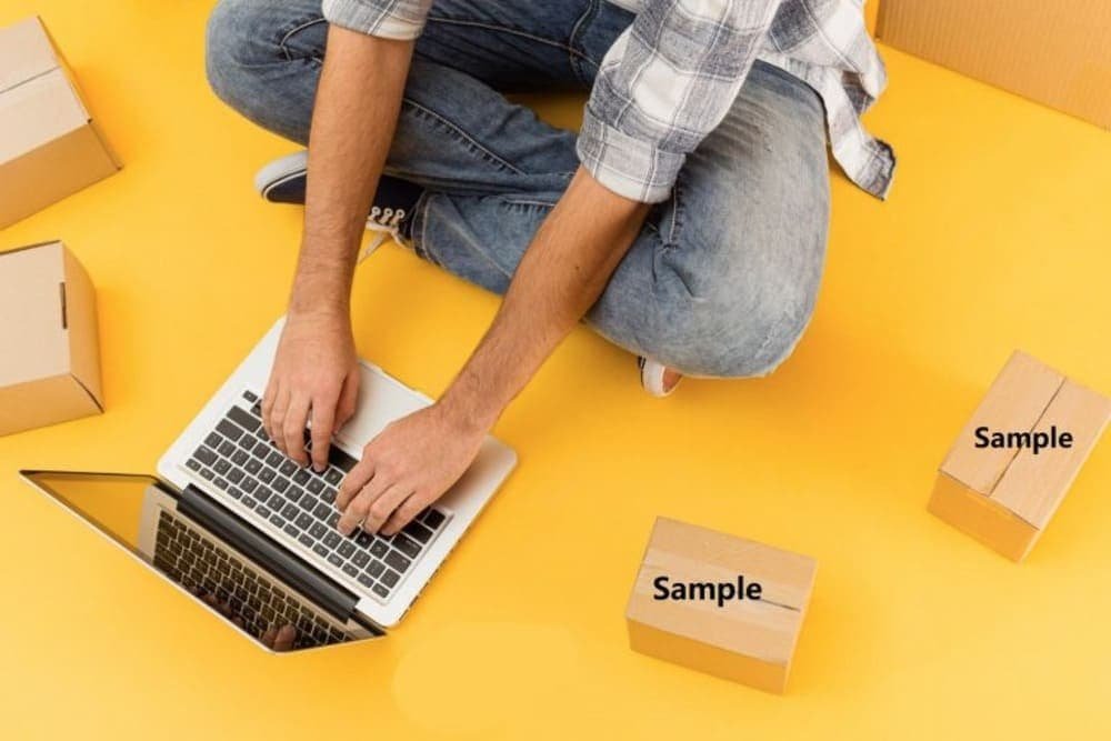Person typing on laptop among “Sample” boxes on yellow background