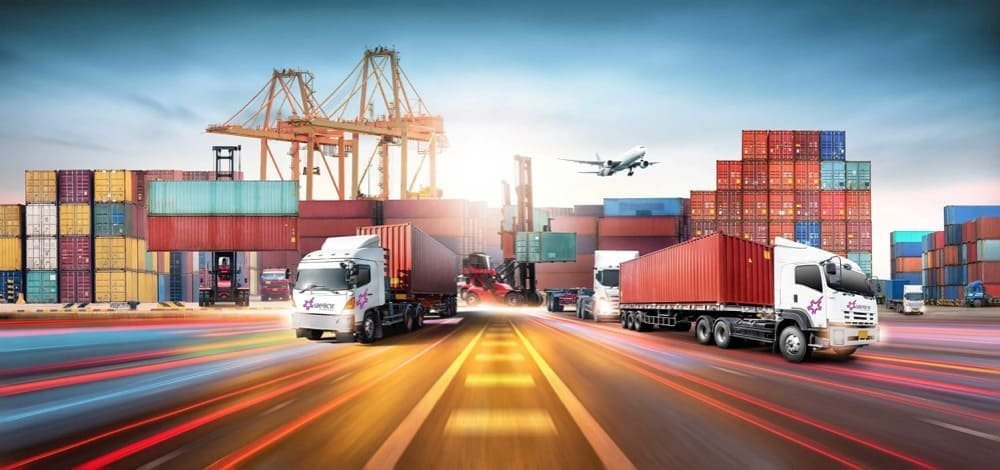 Trucks, shipping containers, cranes, and an airplane at a busy port