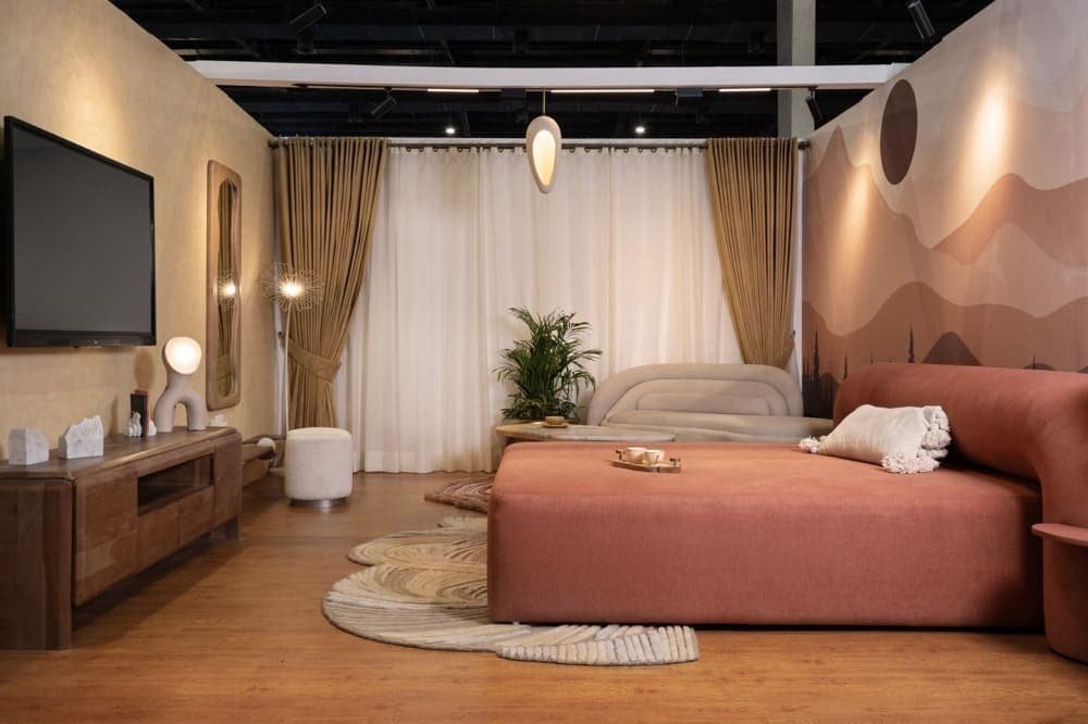 Contemporary living room with rust-colored sofa, abstract mural, wooden entertainment unit, and beige curtains