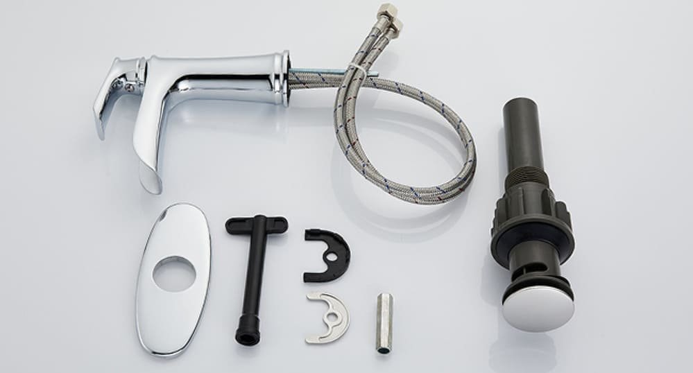 Components of a bathroom faucet set, including a chrome handle, hoses, and a drain assembly