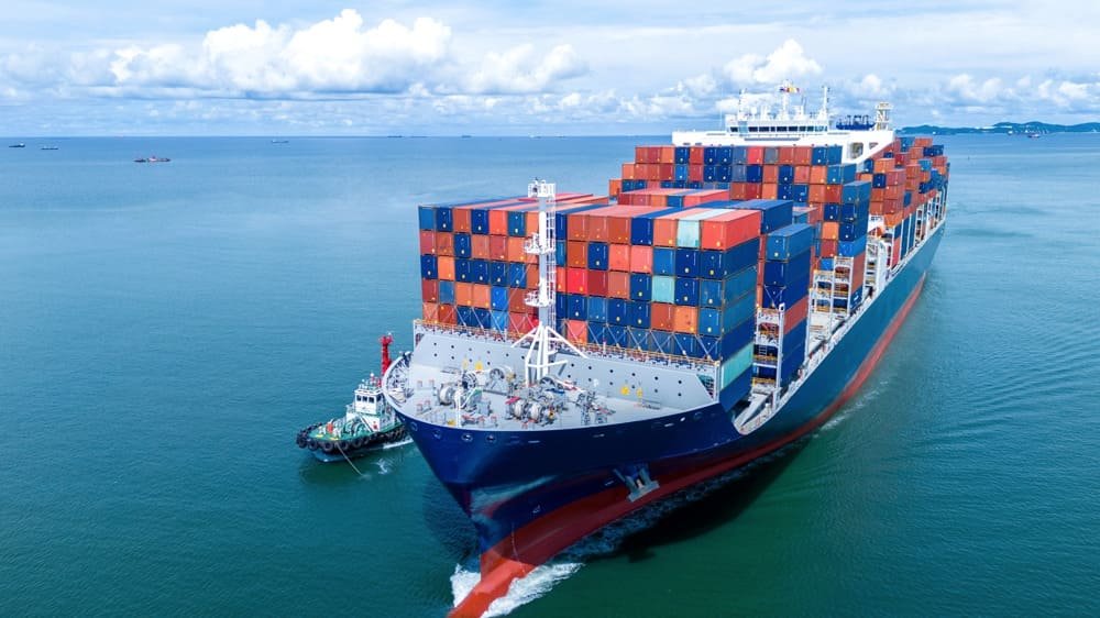 Container ship and tugboat on calm water