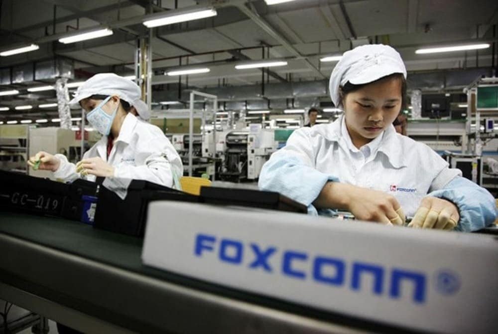 Foxconn factory workers assembling electronics on production line