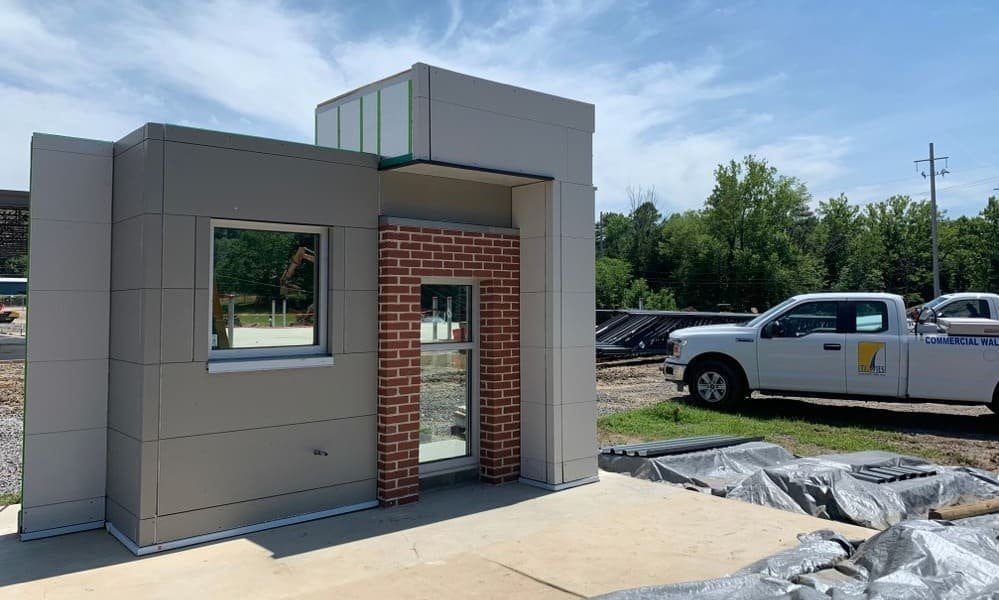 Building mockup with work truck under blue sky