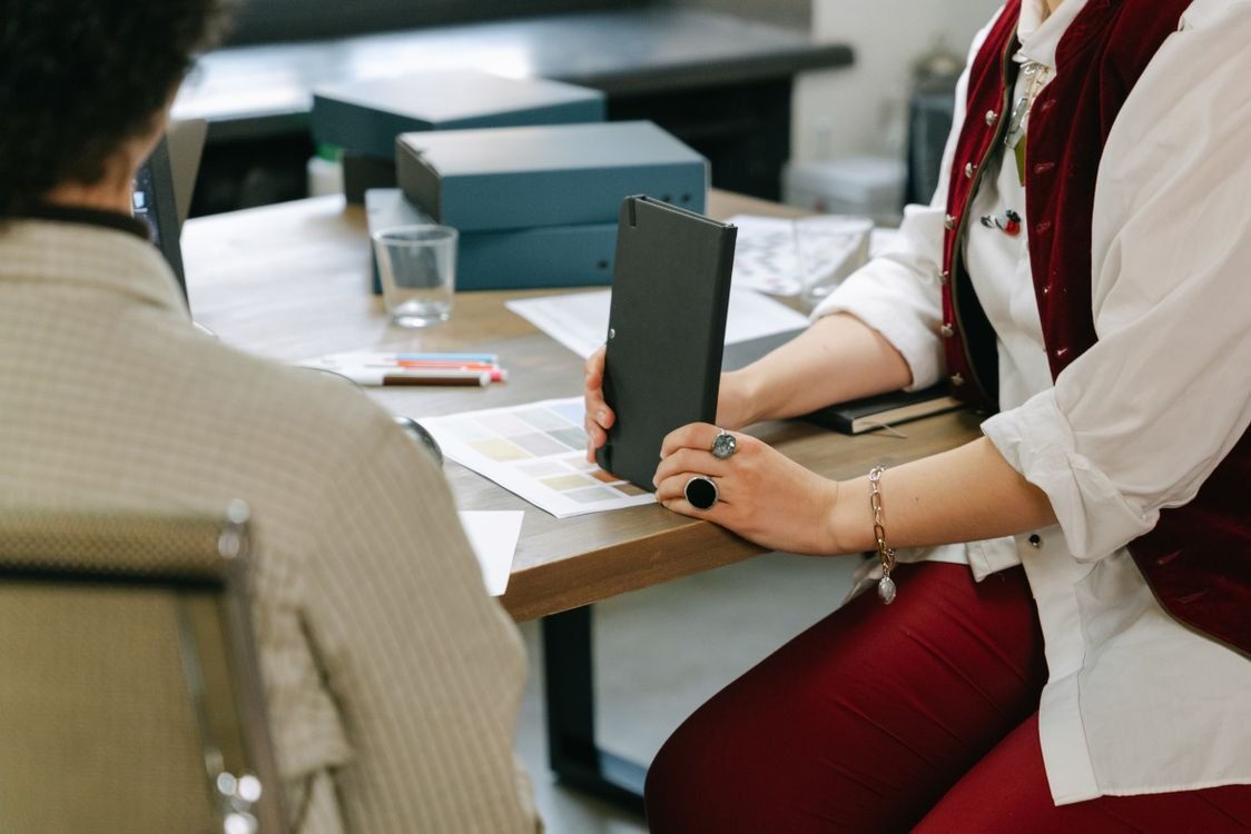 Business team reviewing documents and color samples during a sourcing meeting