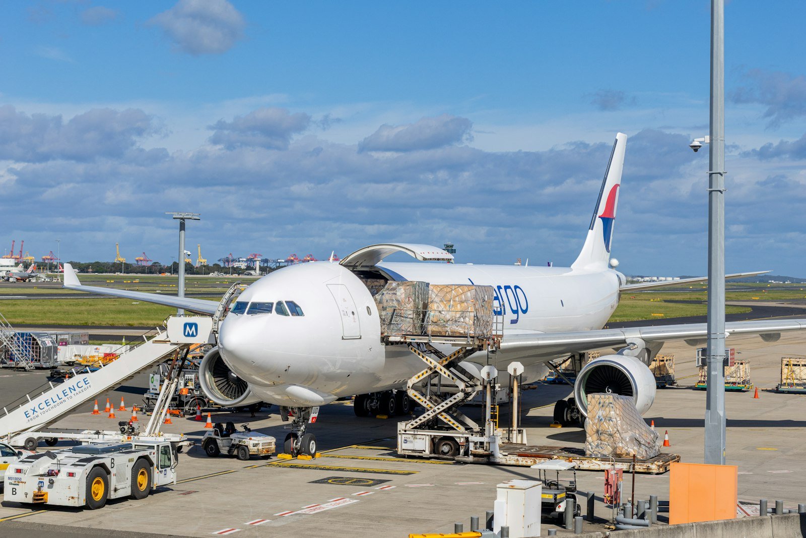 Cargo plane being loaded at an airport tarmac