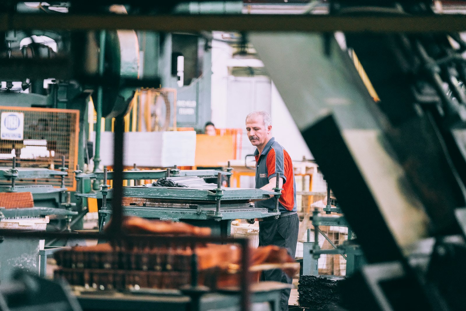 Factory worker operating industrial machinery during production