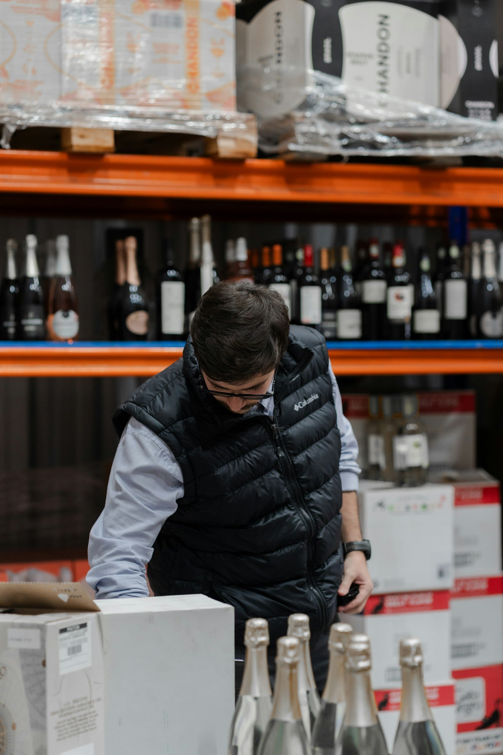 Warehouse worker inspecting products on shelving