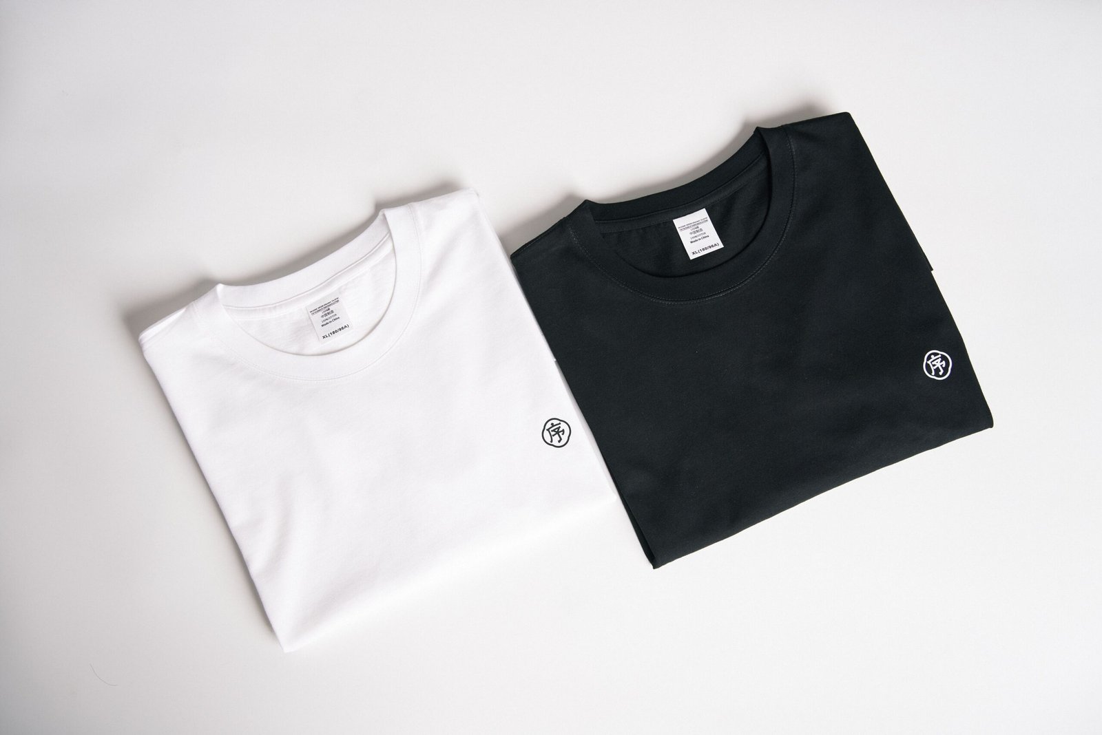 Apparel V4 Casualwear — folded black and white cotton T-shirts